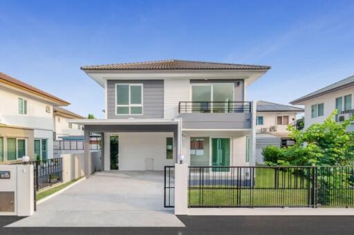 Modern two-story house with spacious driveway and balcony