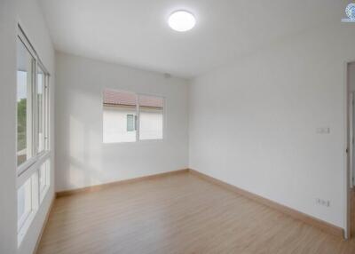 Spacious unfurnished bedroom with large windows and hardwood floors
