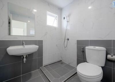 Modern bathroom with grey tiles and white fixtures