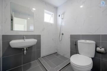 Modern bathroom with grey tiles and white fixtures