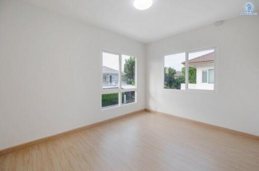 Spacious and bright empty bedroom with large windows