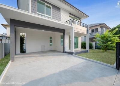Modern residential home exterior with spacious driveway and carport