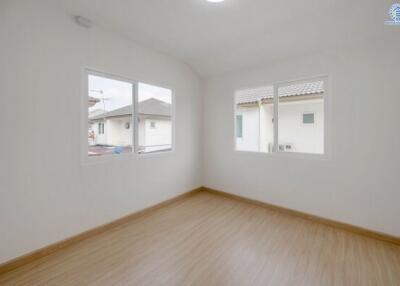 Bright and spacious empty bedroom with two windows