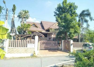 Exterior view of a residential house with a gated fence