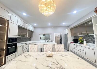 Elegant modern kitchen with marble countertops and sophisticated lighting