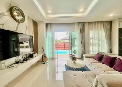 Spacious and bright living room with modern design, overlooking a pool