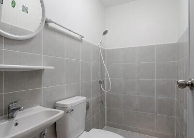 Modern compact bathroom with white tiles and essential fixtures