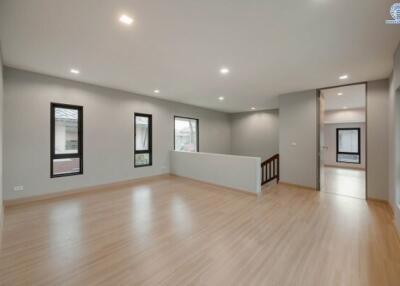 Spacious and well-lit living room with wooden flooring