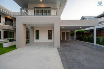 Modern two-story residential home with spacious driveway and balcony