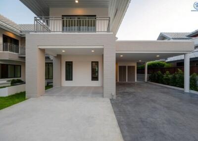 Modern two-story residential home with spacious driveway and balcony