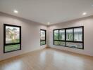 Spacious and bright empty living room with large windows