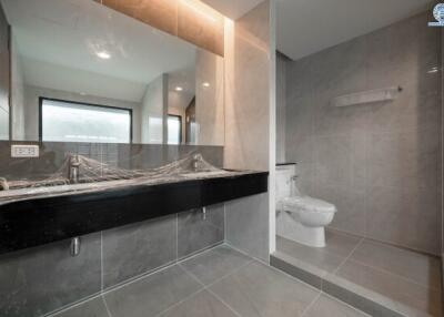Modern bathroom with gray tiles and elegant fixtures