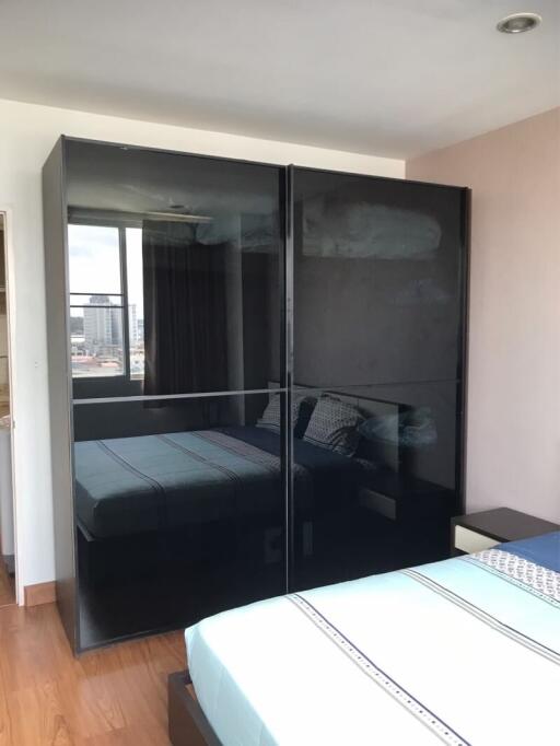 Modern bedroom with large mirrored wardrobe