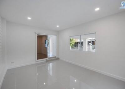Spacious and bright empty living room with glossy white floor