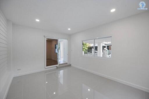 Spacious and bright empty living room with glossy white floor