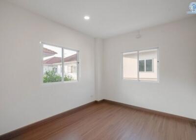 Bright and airy empty bedroom with wooden flooring