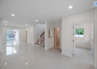 Spacious and brightly lit main entrance hall with staircase