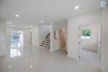 Spacious and brightly lit main entrance hall with staircase