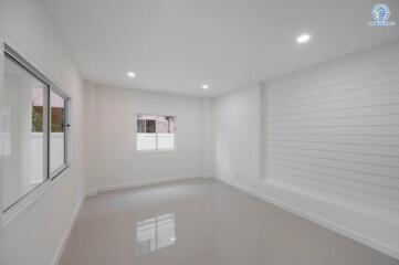 Spacious and well-lit empty bedroom with large windows