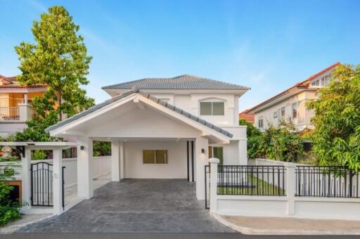 Modern two-story house with landscaped front yard and spacious driveway