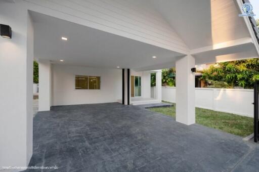 Modern covered patio area with open sliding doors and garden view