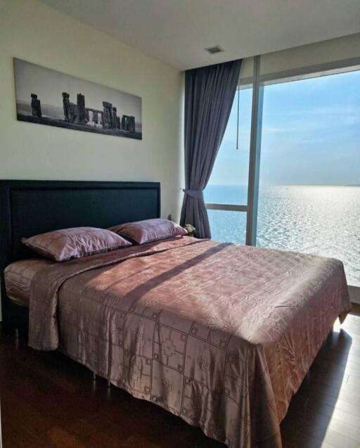 Ocean view bedroom with large windows and contemporary decor