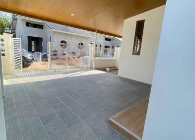 Spacious covered garage area with tiled flooring and modern facade