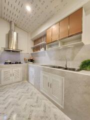 Modern kitchen with marble countertops and wooden cabinets