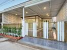 Elegant residential house front view showcasing carport and gated entrance