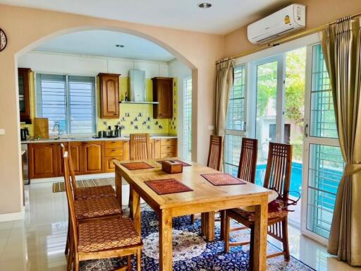 Spacious kitchen with dining area featuring wooden cabinets and modern amenities