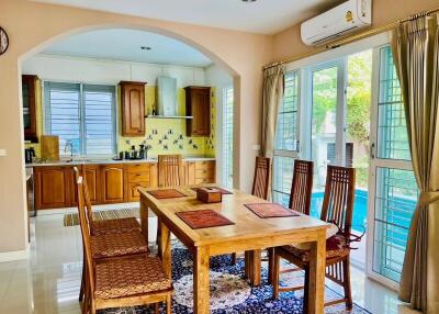 Spacious kitchen with dining area featuring wooden cabinets and modern amenities