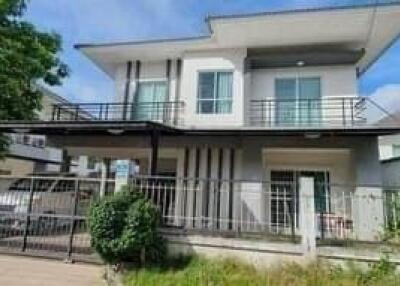 Modern two-story residential house with balcony and landscaped front yard