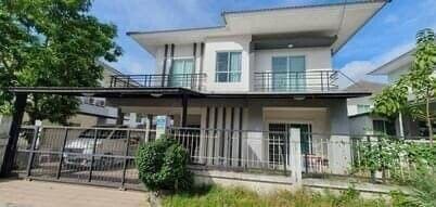 Modern two-story residential house with balcony and landscaped front yard