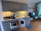 Modern kitchen with integrated appliances and adjacent living area