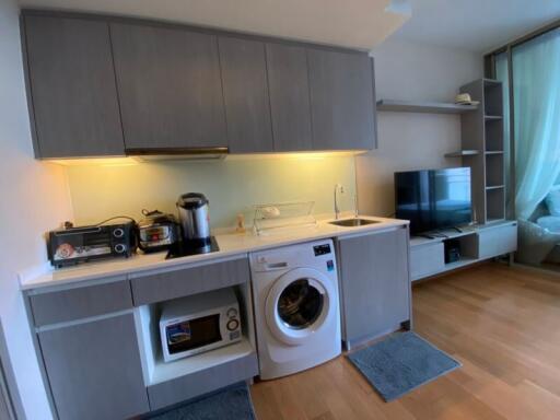 Modern kitchen with integrated appliances and adjacent living area