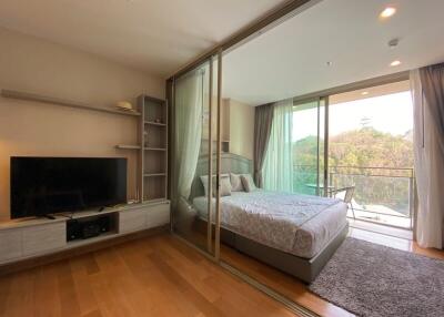 Spacious bedroom with large sliding glass doors leading to a balcony