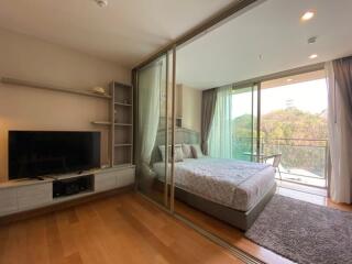 Spacious bedroom with large sliding glass doors leading to a balcony