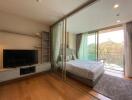 Spacious bedroom with large sliding glass doors leading to a balcony