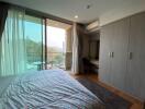 Spacious bedroom with scenic view and balcony access