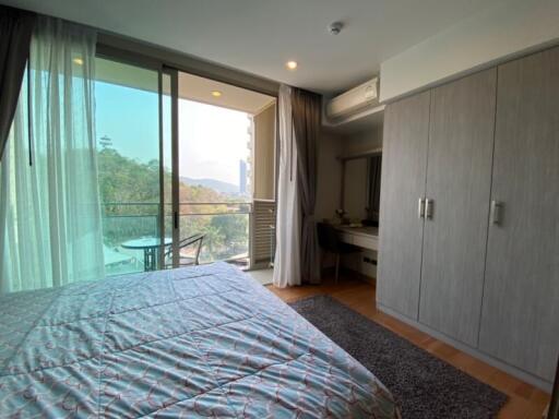 Spacious bedroom with scenic view and balcony access