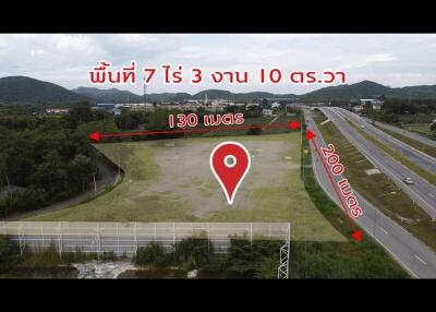 aerial view of a vacant land near a highway with distance markers to nearby destinations
