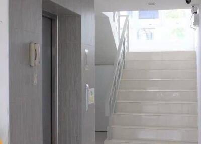 Modern home entrance with elevator and staircase