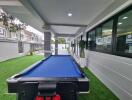 Spacious outdoor area with pool table and modern architecture