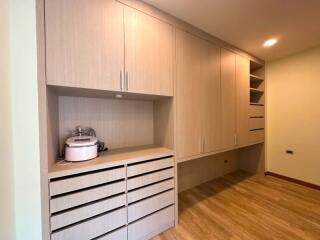 Modern minimalist kitchen with built-in cabinets and wooden flooring