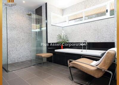 Modern bathroom with glass shower enclosure and elegant seating