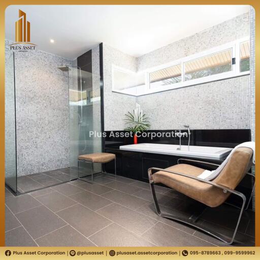 Modern bathroom with glass shower enclosure and elegant seating