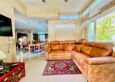 Spacious and brightly lit living room with large sectional sofa and modern amenities