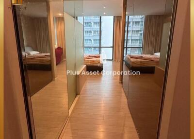 Spacious bedroom with mirrored wardrobe doors and balcony access in a modern apartment