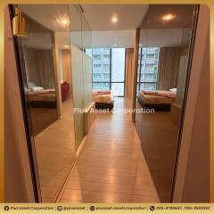 Spacious bedroom with mirrored wardrobe doors and balcony access in a modern apartment