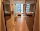 Spacious bedroom with mirrored wardrobe doors and balcony access in a modern apartment